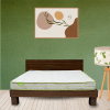 A cozy bedroom featuring a neatly made bed beside a stylish nightstand, creating a serene and inviting atmosphere.